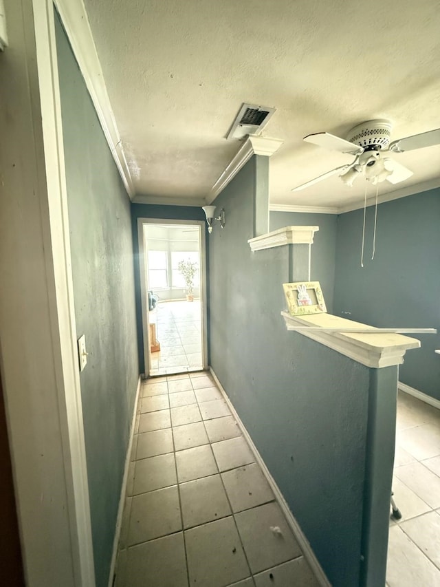 15125 S Dr, Channelview, TX 77530 - doorway with tile patterned floors, crown molding, baseboards, a textured ceiling, and a ceiling fan