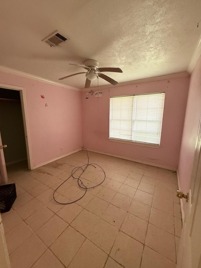 15125 S Dr, Channelview, TX 77530 - spare room with ornamental molding, ceiling fan, light tile patterned floors, baseboards, and a textured ceiling