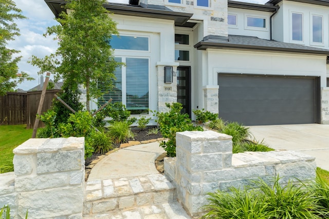 1918 Longcroft Ln, Katy, TX 77493 - entrance to property featuring stucco siding, a garage, driveway, and stone siding