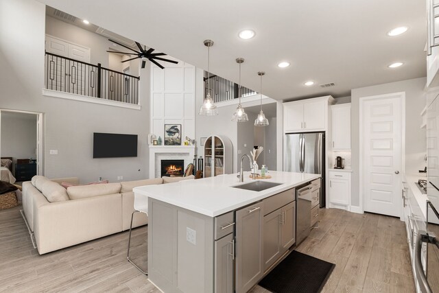 1918 Longcroft Ln, Katy, TX 77493 - kitchen featuring a sink, appliances with stainless steel finishes, gray cabinetry, open floor plan, and recessed lighting