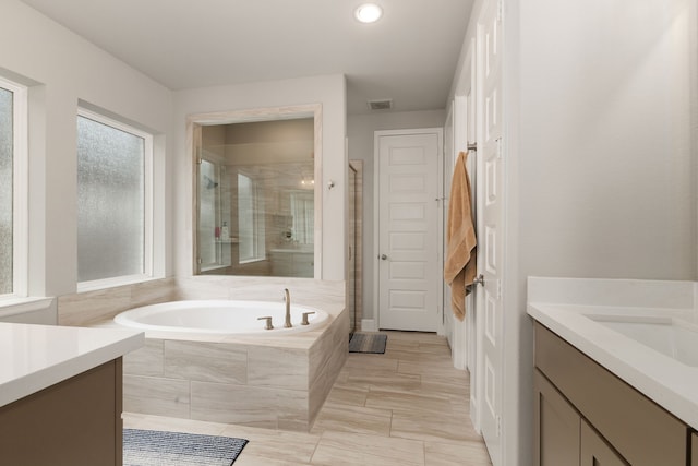 1918 Longcroft Ln, Katy, TX 77493 - bathroom featuring vanity, a shower stall, a garden tub, and recessed lighting