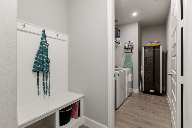 1918 Longcroft Ln, Katy, TX 77493 - laundry room featuring washer and dryer, baseboards, light wood finished floors, and recessed lighting