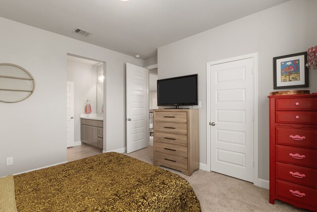 1918 Longcroft Ln, Katy, TX 77493 - bedroom with light colored carpet, baseboards, and ensuite bathroom