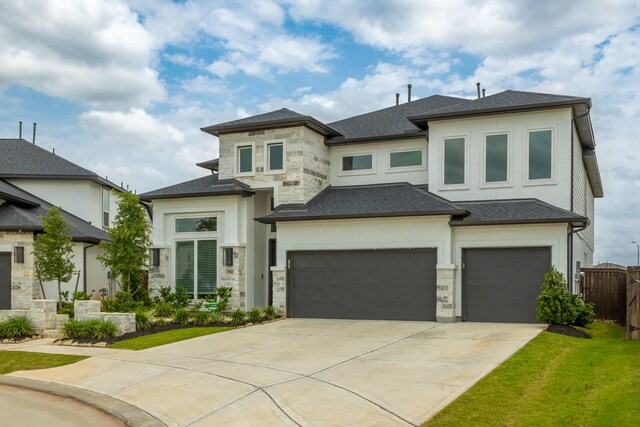 1918 Longcroft Ln, Katy, TX 77493 - prairie-style home with stone siding, concrete driveway, a shingled roof, and stucco siding
