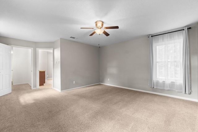 28 Silver Elm Pl, The Woodlands, TX 77381 - spare room with ceiling fan, light carpet, and baseboards