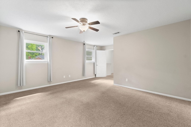 28 Silver Elm Pl, The Woodlands, TX 77381 - carpeted spare room with a ceiling fan, baseboards, and a textured ceiling