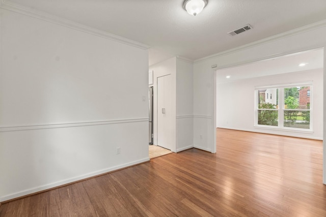 28 Silver Elm Pl, The Woodlands, TX 77381 - unfurnished room featuring wood finished floors, ornamental molding, and baseboards