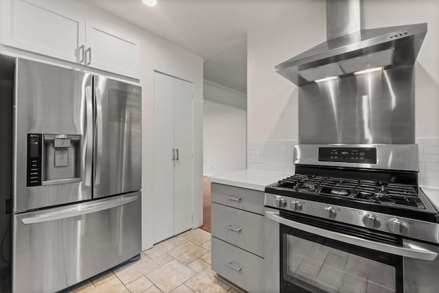 28 Silver Elm Pl, The Woodlands, TX 77381 - kitchen with stainless steel appliances, decorative backsplash, light countertops, stone tile flooring, and white cabinets