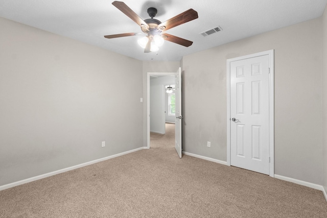 28 Silver Elm Pl, The Woodlands, TX 77381 - unfurnished bedroom featuring light colored carpet, baseboards, and a ceiling fan