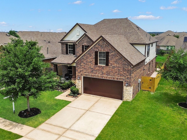 24618 Ballad Dr, Katy, TX 77493 - view of front of property with stone siding, brick siding, an attached garage, roof with shingles, and driveway