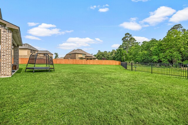 14121 N Lake Branch Ln, Houston, TX 77044 - view of yard with a trampoline