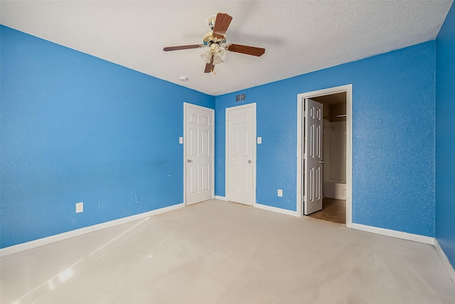 8100 Creekbend Dr Unit 146, Houston, TX 77071 - unfurnished bedroom featuring baseboards, carpet floors, a ceiling fan, and a textured wall