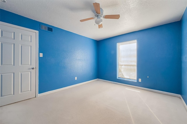 8100 Creekbend Dr Unit 146, Houston, TX 77071 - spare room featuring a textured ceiling, baseboards, carpet flooring, and a ceiling fan