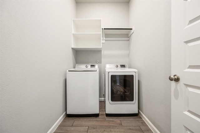 10522 Rigel Ridge Way, Richmond, TX 77406 - laundry area featuring washer and dryer, wood finished floors, and baseboards