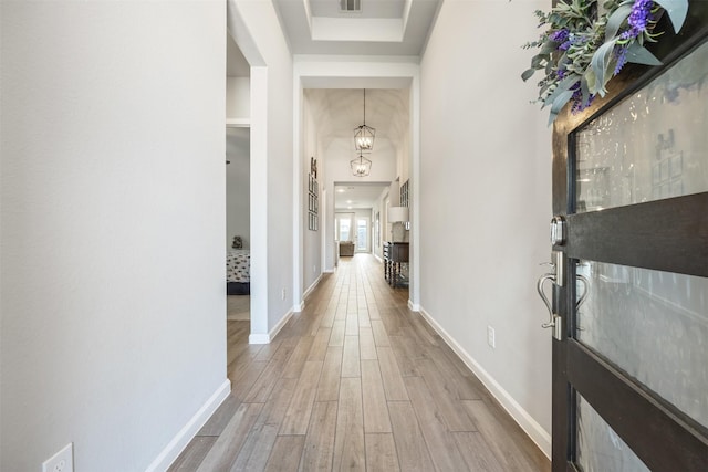 10522 Rigel Ridge Way, Richmond, TX 77406 - hall with wood finished floors, baseboards, a chandelier, and a raised ceiling