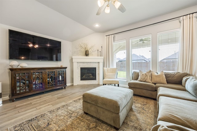 10522 Rigel Ridge Way, Richmond, TX 77406 - living room with a ceiling fan, wood finished floors, baseboards, lofted ceiling, and a glass covered fireplace