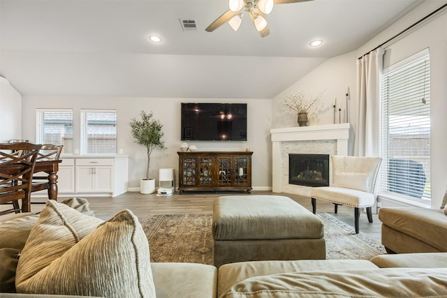 10522 Rigel Ridge Way, Richmond, TX 77406 - living room with vaulted ceiling, ceiling fan, wood finished floors, baseboards, and a glass covered fireplace