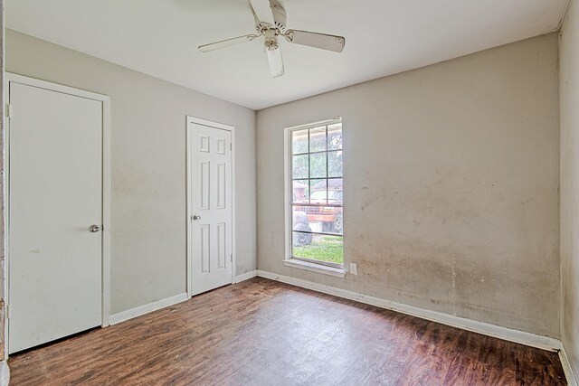 1006 Fruitvale Dr, Houston, TX 77038 - unfurnished bedroom with wood finished floors, baseboards, and a ceiling fan