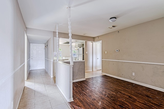 1006 Fruitvale Dr, Houston, TX 77038 - kitchen with freestanding refrigerator, baseboards, light countertops, and light wood-style flooring