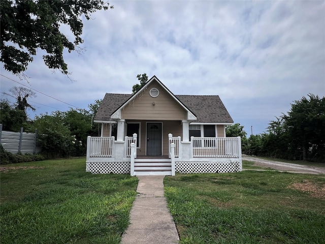 5433 Bunte St, Houston, TX 77026 - bungalow-style home featuring covered porch, roof with shingles, and a front yard