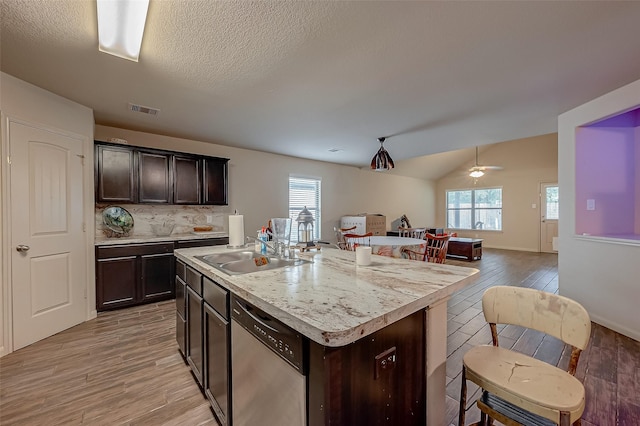 2026 Naplechase Crest Dr, Spring, TX 77373 - kitchen featuring a sink, light countertops, light wood finished floors, dark brown cabinets, and open floor plan
