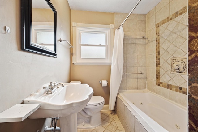 7658 El Rancho St, Houston, TX 77087 - full bathroom with a combined bath / shower with jetted tub, toilet, tile patterned floors, and baseboards
