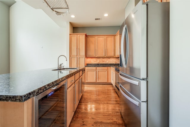 2915 Pease St, Houston, TX 77003 - kitchen with stainless steel appliances, a sink, wine cooler, backsplash, and recessed lighting