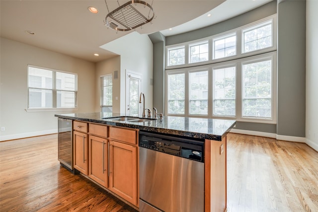 2915 Pease St, Houston, TX 77003 - kitchen with stainless steel dishwasher, beverage cooler, a sink, dark stone countertops, and recessed lighting