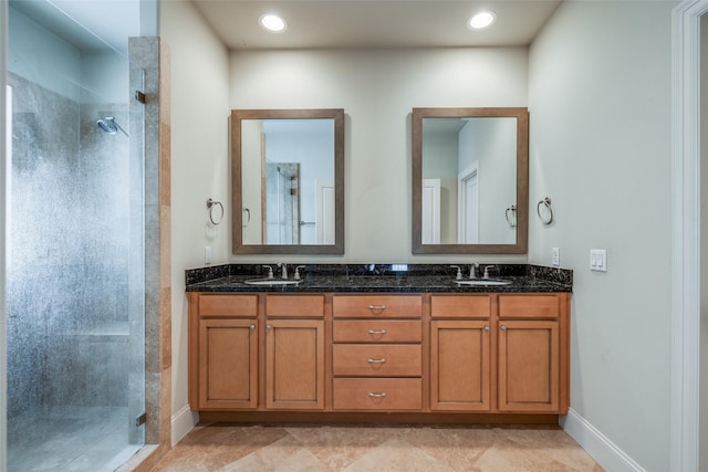 2915 Pease St, Houston, TX 77003 - full bathroom featuring a shower stall, double vanity, and baseboards