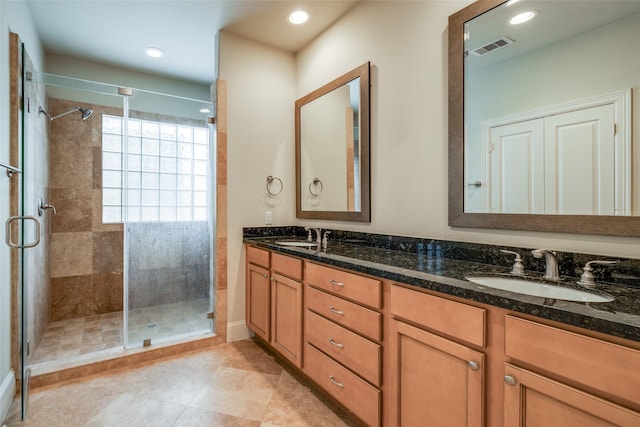 2915 Pease St, Houston, TX 77003 - bathroom featuring a shower stall, double vanity, recessed lighting, and tile patterned floors