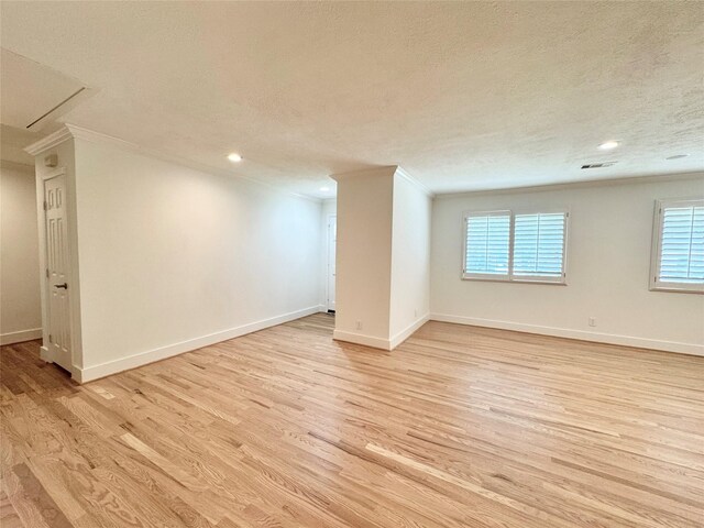 5010 Redstart St, Houston, TX 77035 - below grade area featuring ornamental molding, light wood-type flooring, a textured ceiling, healthy amount of natural light, and baseboards
