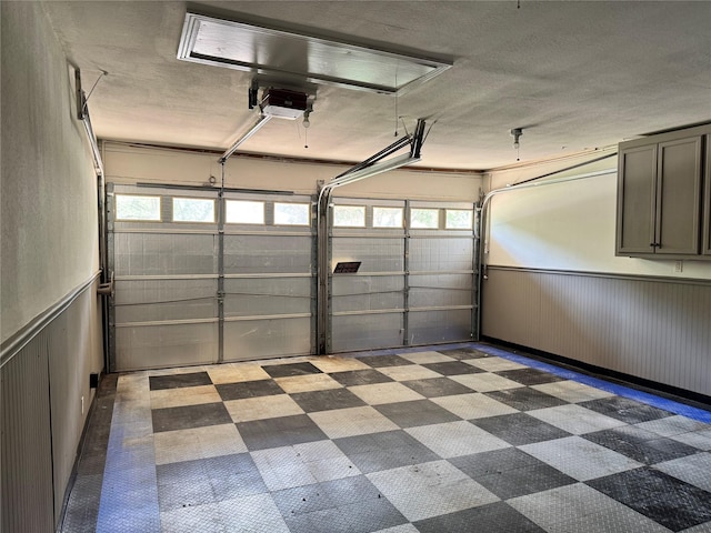 5010 Redstart St, Houston, TX 77035 - garage featuring wainscoting and a garage door opener