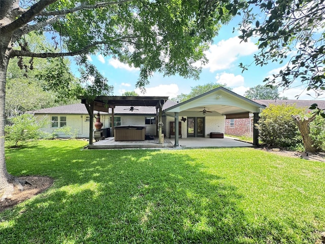 5010 Redstart St, Houston, TX 77035 - back of house with a hot tub, ceiling fan, a patio area, a lawn, and brick siding
