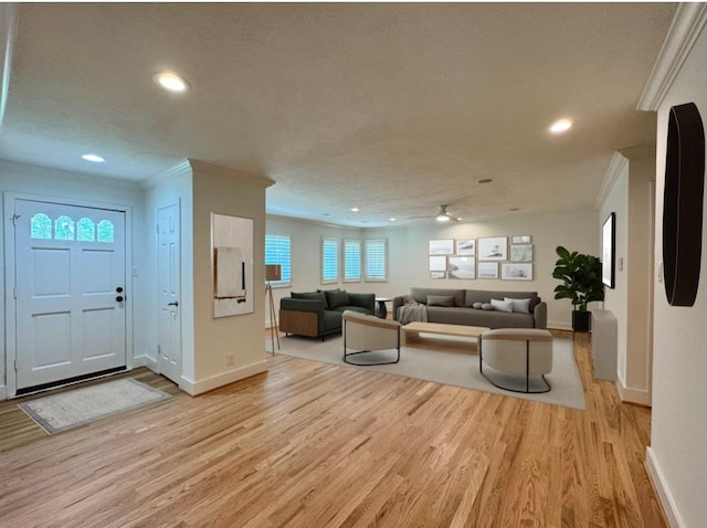 5010 Redstart St, Houston, TX 77035 - living area featuring light wood-type flooring, baseboards, recessed lighting, ornamental molding, and a textured ceiling
