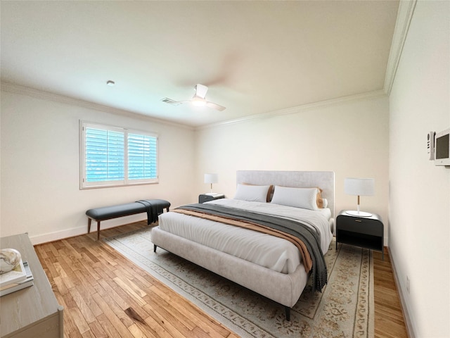 5010 Redstart St, Houston, TX 77035 - bedroom featuring crown molding, light wood finished floors, baseboards, and ceiling fan