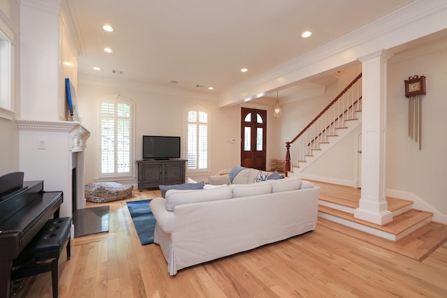 1132 Oxford St, Houston, TX 77008 - living area featuring stairs, light wood finished floors, crown molding, recessed lighting, and a fireplace