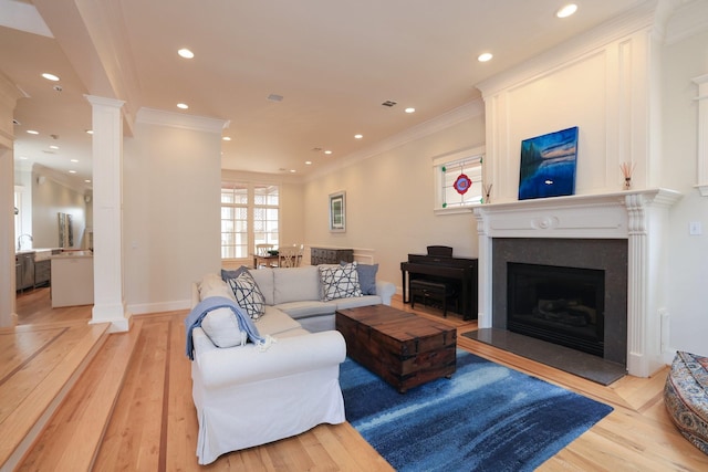 1132 Oxford St, Houston, TX 77008 - living room with ornamental molding, decorative columns, light wood finished floors, recessed lighting, and a fireplace