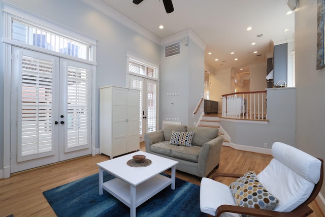 1132 Oxford St, Houston, TX 77008 - living area with ornamental molding, a towering ceiling, a ceiling fan, wood finished floors, and stairway
