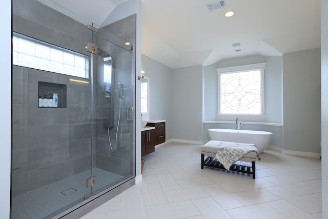 1132 Oxford St, Houston, TX 77008 - bathroom with healthy amount of natural light, lofted ceiling, a stall shower, vanity, and a soaking tub