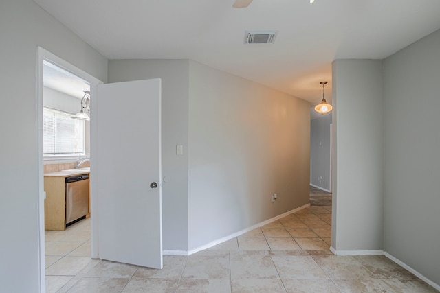 5902 Yorkgate Dr, Spring, TX 77373 - empty room featuring light tile patterned flooring, a sink, and baseboards
