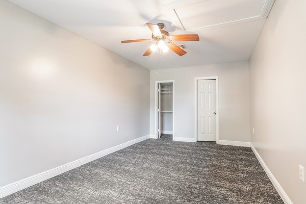 3322 Mccrarey Dr, Houston, TX 77088 - unfurnished bedroom featuring dark carpet, baseboards, and ceiling fan