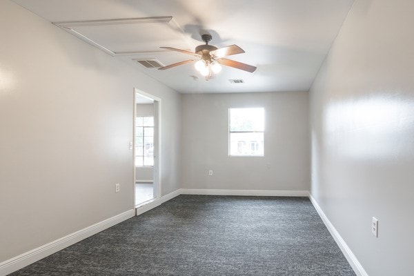3322 Mccrarey Dr, Houston, TX 77088 - empty room featuring a ceiling fan, attic access, dark carpet, and baseboards