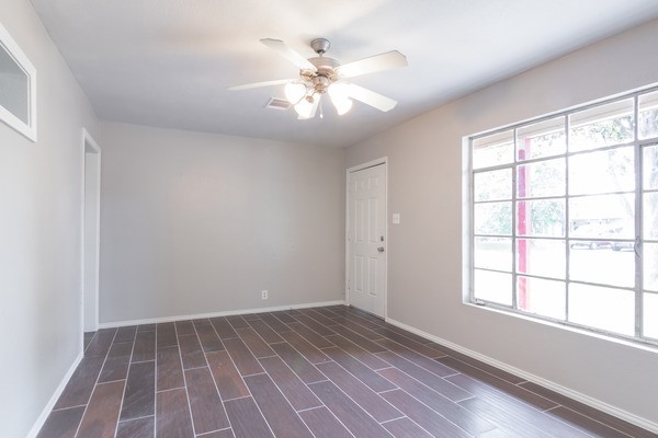 3322 Mccrarey Dr, Houston, TX 77088 - unfurnished room with a ceiling fan, baseboards, and dark wood-type flooring