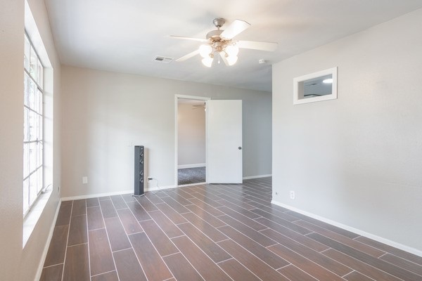 3322 Mccrarey Dr, Houston, TX 77088 - empty room featuring ceiling fan, baseboards, and wood finished floors