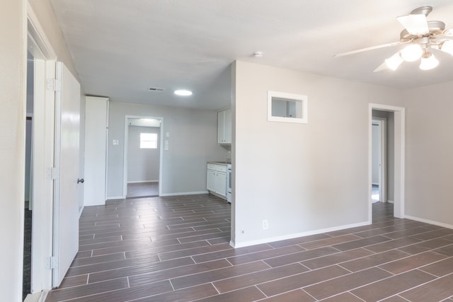3322 Mccrarey Dr, Houston, TX 77088 - kitchen with wood finish floors, baseboards, ceiling fan, and white cabinetry