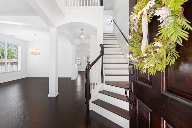 3901 Kimberly Dr, Pearland, TX 77581 - entrance foyer featuring arched walkways, stairway, wood finished floors, and baseboards