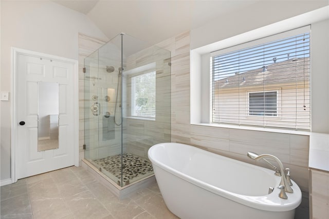 3901 Kimberly Dr, Pearland, TX 77581 - full bathroom with a freestanding tub, a stall shower, marble finish floors, lofted ceiling, and tile walls