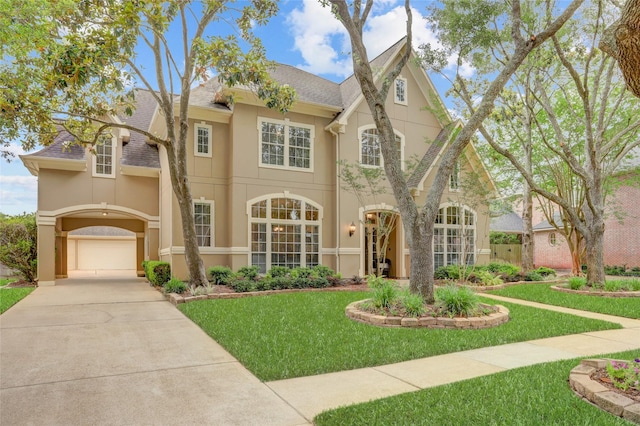 3807 Snead Ct, Sugar Land, TX 77479 - view of front facade featuring stucco siding, driveway, a front yard, and an attached garage
