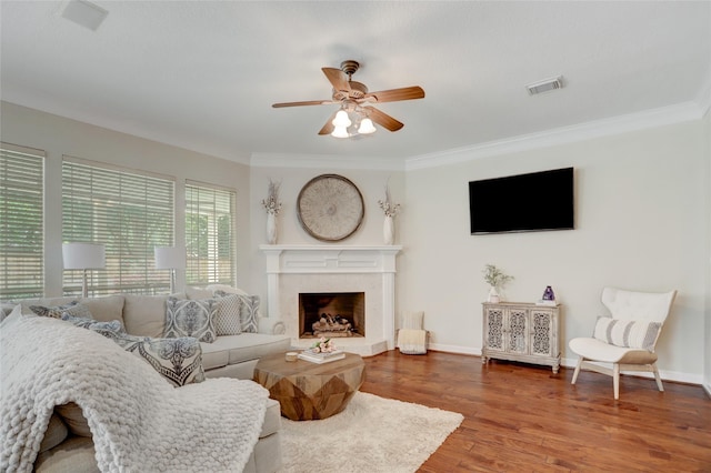 3807 Snead Ct, Sugar Land, TX 77479 - living room featuring ceiling fan, crown molding, wood finished floors, a fireplace, and baseboards