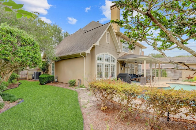 3807 Snead Ct, Sugar Land, TX 77479 - rear view of property with a ceiling fan, a chimney, stucco siding, a patio area, and roof with shingles